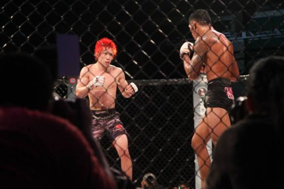 Tanaka and Aguon's very looks cautious in the second round of their PXC 40 fight - Photo by 671mma.com